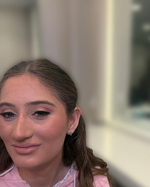 Soft daytime makeup, hair worn in braids